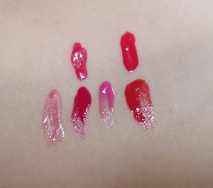 Top: YSL Glossy Stain in 13 Rose Tempura and 11 Rouge Gouache Bottom: L'Oreal Caresse Aqua Lacquer in Rose On and On, Infinite Fuchsia, Pink Rebellion and Endless Red